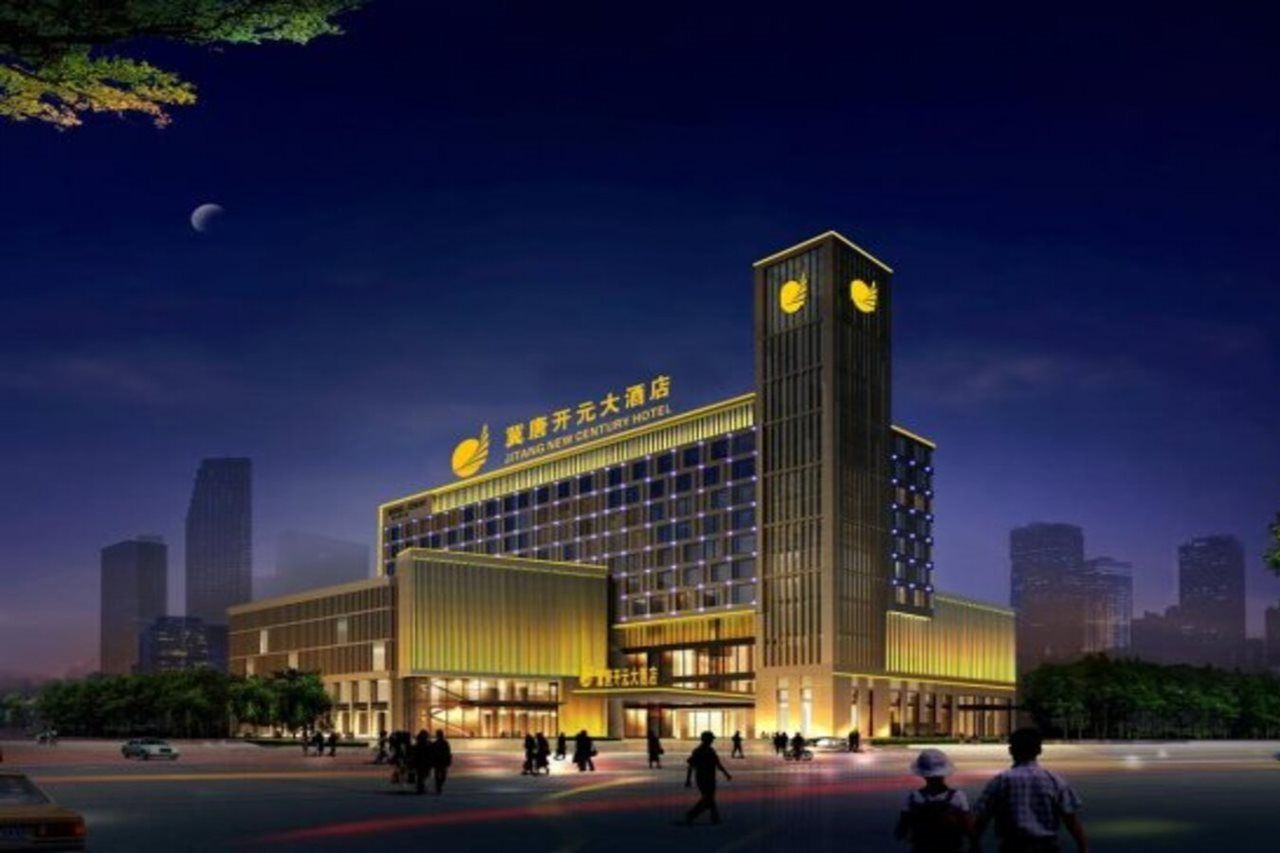 A modern hotel building with a prominent tower and a large entrance.