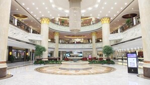 A spacious atrium with a central fountain, marble floors, and multiple levels with balconies. - Empark Grand Hotel Fuzhou (Fuzhou)
