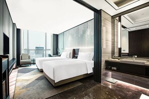 A modern hotel room with two beds, a large mirror, a vanity with a sink, and a city view. - Holiday Inn Taiyuan City Center by IHG (Taiyuan)