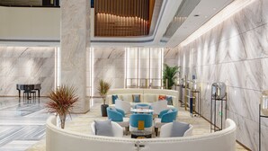 A modern lobby with a seating area, a piano, and a plant. - Holiday Inn Taiyuan City Center by IHG (Taiyuan)