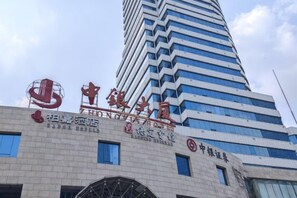 A building with signage for 'Zhongxin Hotel' and 'Sage Hotel'. - Zhongyin Hotel (Baoding)