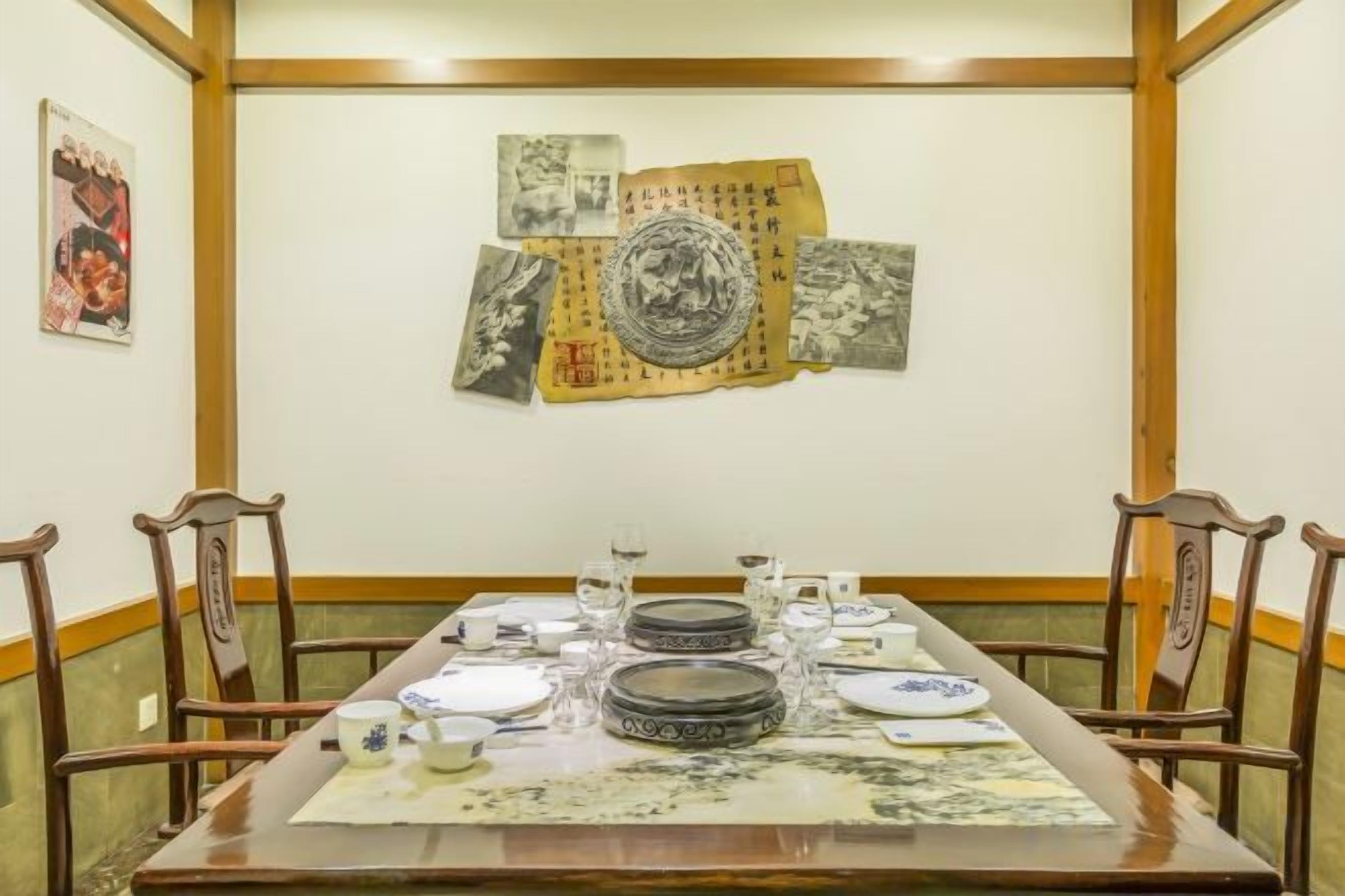 A dining table set with plates, bowls, and cups, surrounded by wooden chairs.
