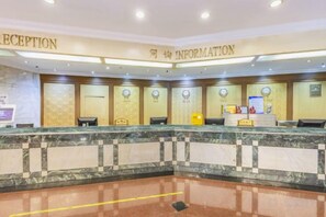 A hotel reception area with a marble counter, reception desk, and information desk. - Zhongyin Hotel (Baoding)