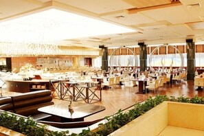 A spacious hotel lobby with multiple seating areas, a central bar, and large windows. - Tangshan Shengquan Hot Spring Hotel (Nanjing)