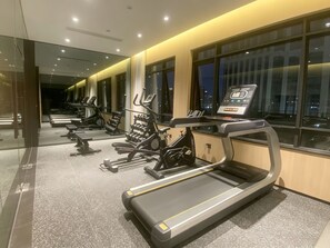 A gym with treadmills, stationary bikes, and weight machines.