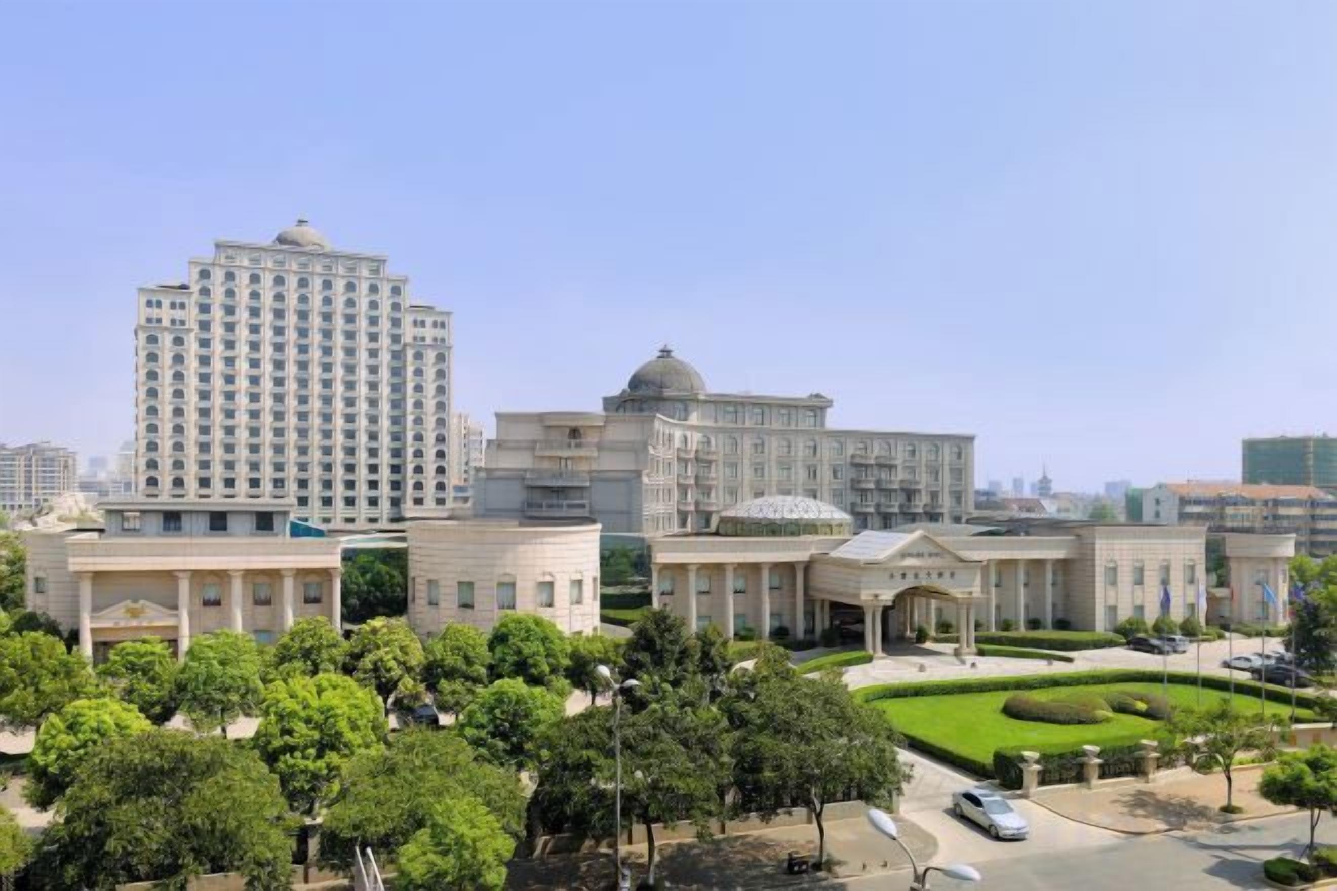A large building complex with multiple structures, including a tall building and several smaller buildings with domed roofs.