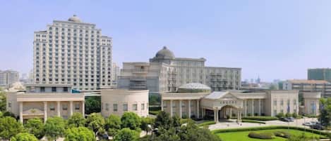 A large building complex with multiple structures, including a tall building and several smaller buildings with domed roofs.