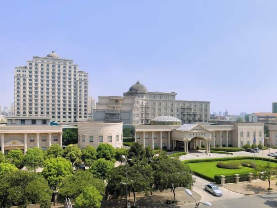 A large building complex with multiple structures, including a tall building and several smaller buildings with domed roofs.