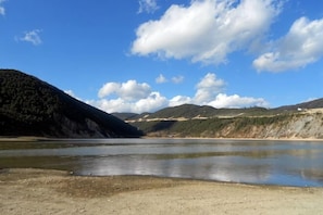 A natural landscape with a body of water, hills, and a clear sky. - Shangri-La Ziyouxing Hotel (Deqin)