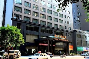 A multi-story building with a prominent sign for Yuzhu Garden Hotel.