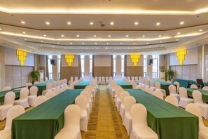 A conference room with rows of tables and chairs, equipped with ceiling lights and a carpeted floor. - Yuzhu Garden Hotel (Chongqing)