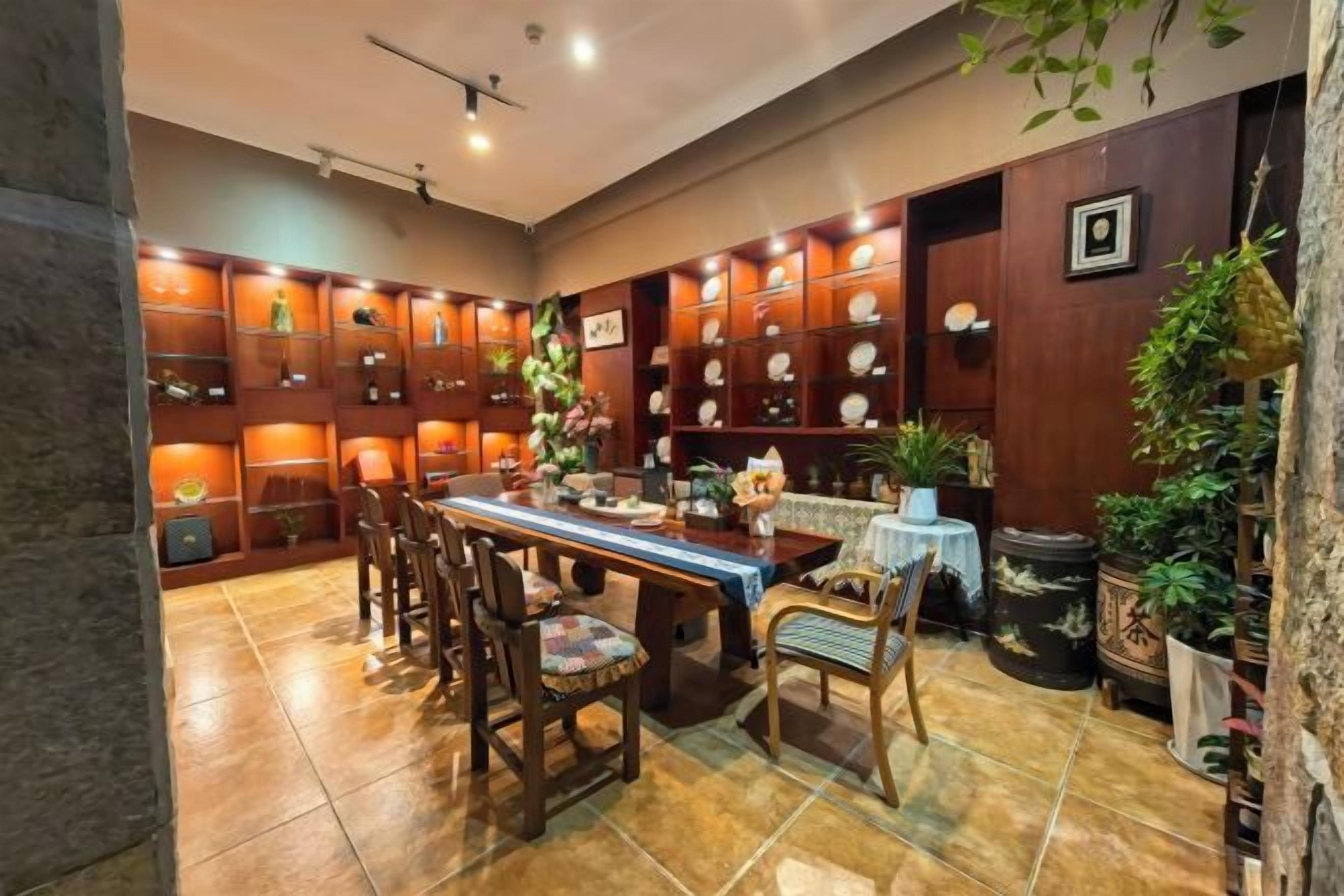 A dining area with a long table, chairs, and a decorative centerpiece.