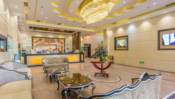 A hotel lobby with a reception desk, seating area, and a chandelier. - GreenTree Inn Guangzhou Chimelong Paradise Yuangang Metro Station Hotel (Guangzhou)