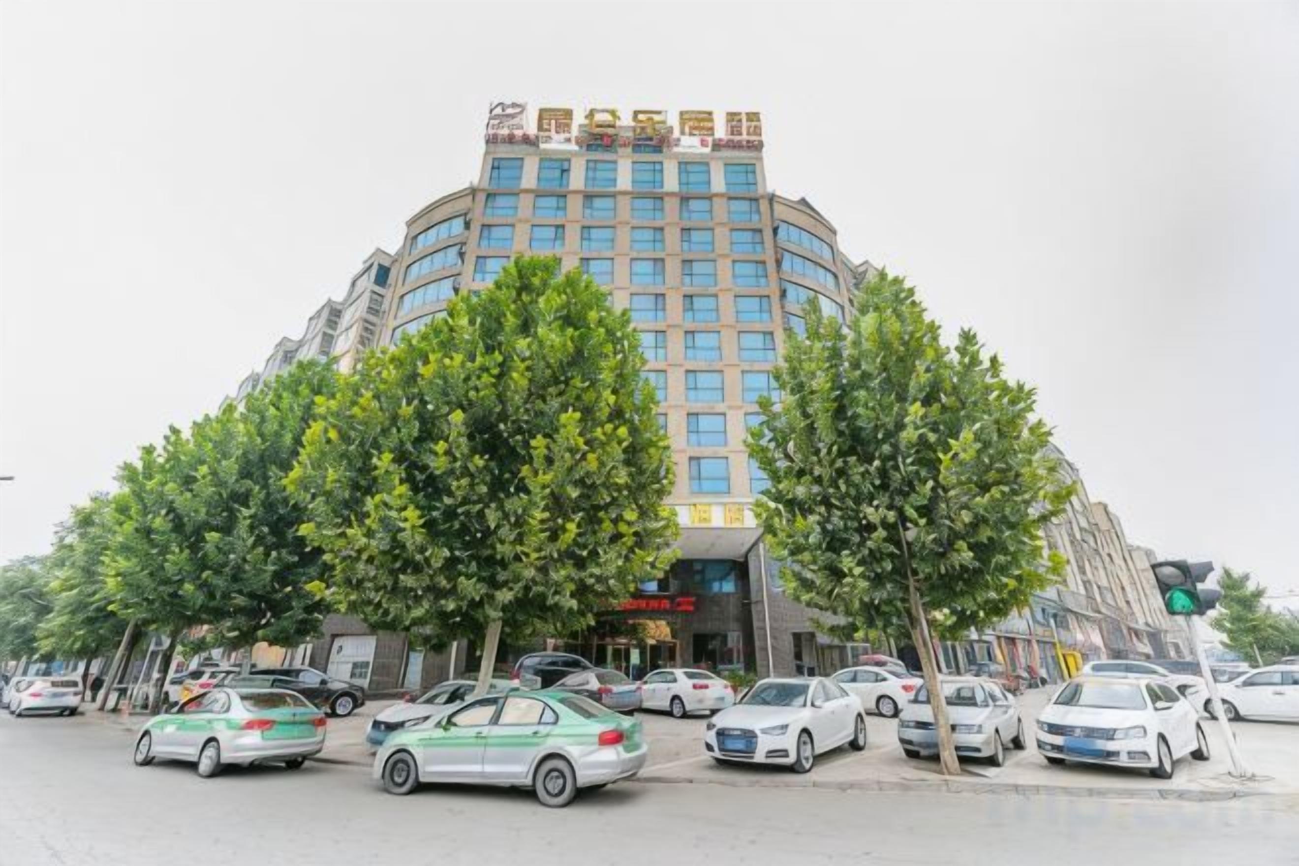 A multi-story hotel with a curved facade, multiple floors, and a prominent entrance.