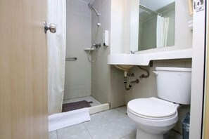 A bathroom with a toilet, sink, shower, and a mirror above the sink. - Jinjiang Inn Fuyang Yingshang Road (Fuyang)