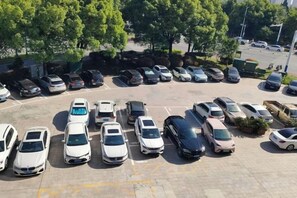 A parking lot with multiple rows of parked cars. - Jiaqi Landscape Hotel (Chizhou)