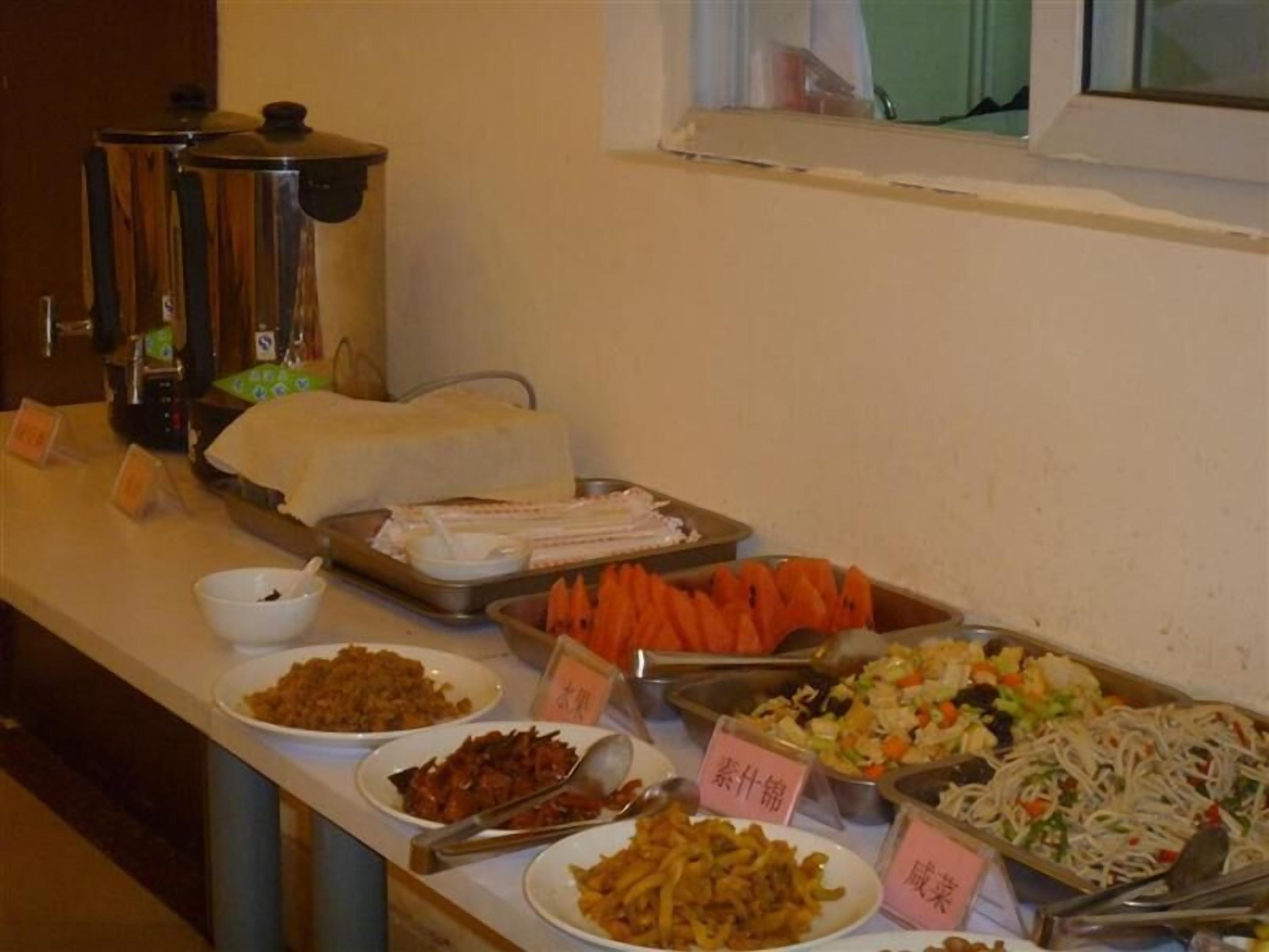 A buffet with various dishes and labeled containers.