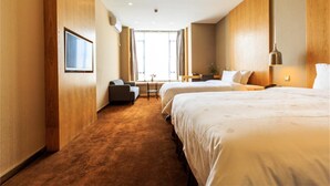A hotel room with two beds, a sofa, a desk, and a window with curtains. - Art Hotel (Shenzhen)