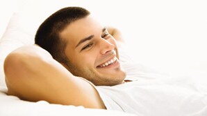 A person lying in bed with white bedding. - Holiday Inn Beijing Airport Zone by IHG (Beijing)