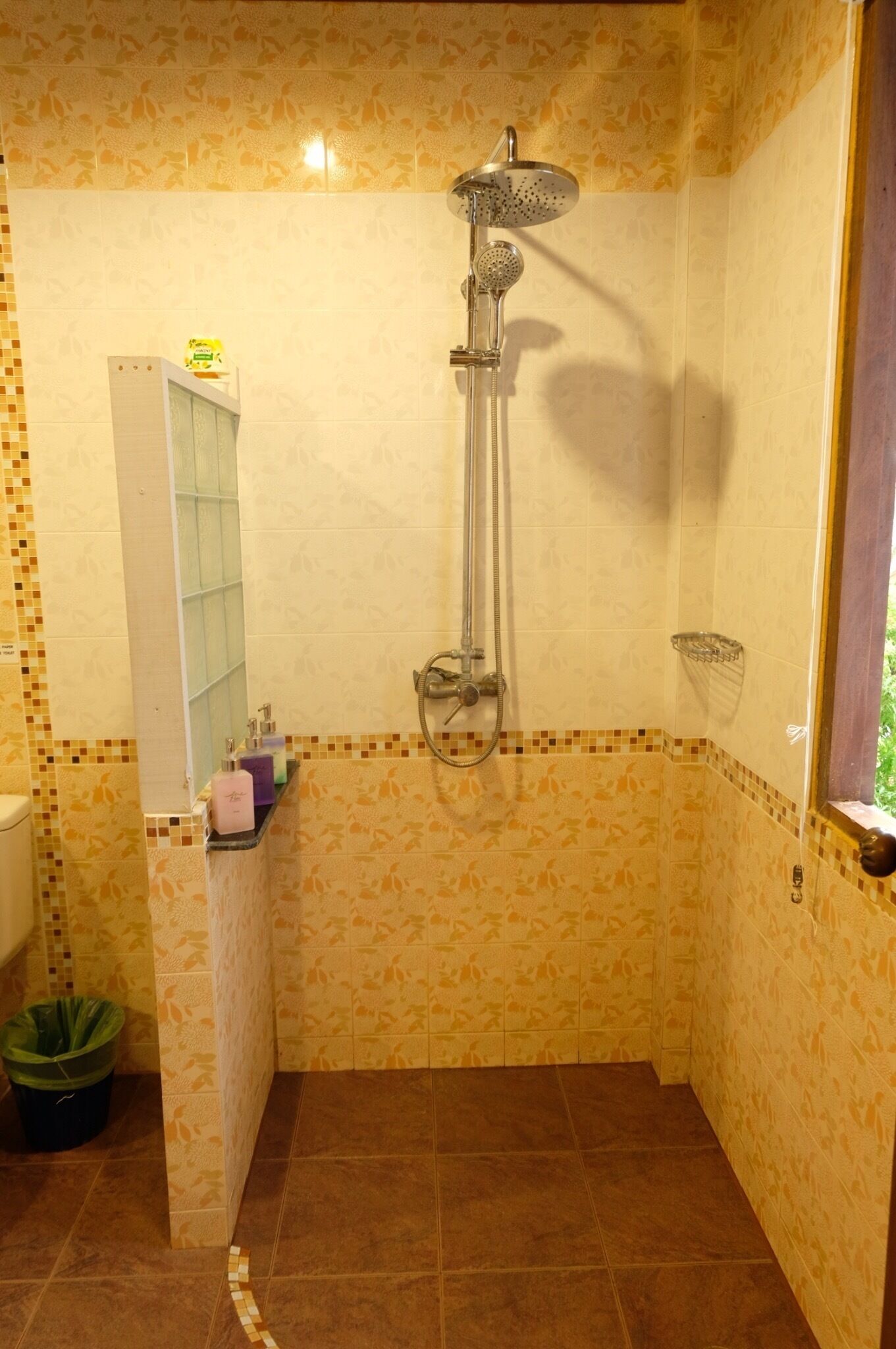 A bathroom with a shower, a toilet, and a sink.