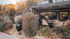 A hotel with a modern design, featuring a rooftop terrace with seating and a view of the surrounding landscape. - Rives d'Or Hôtel (La Seyne-sur-Mer)