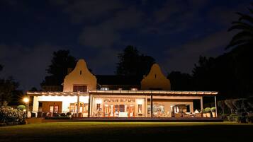 Vista frontal de la propiedad por la tarde o noche