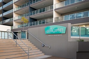 A modern building with a sign for 'Allure Hotel & Apartments'. - Allure Hotel & Apartments (South Townsville)