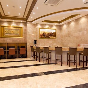 A conference room with a long table, chairs, a painting, and a decorative wall panel.