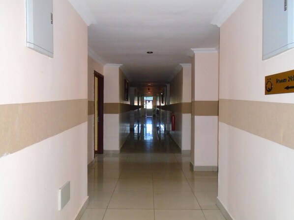 Guests can access their rooms via this well-lit corridor with a simple striped pattern on the walls.