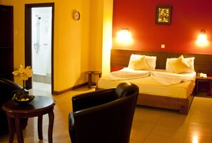 Relax in a stylish room with a comfortable bed, bedside table, and large window offering a view of the outside.