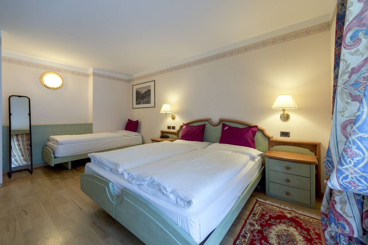Triple Room | Down comforters, in-room safe, desk, blackout drapes