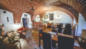 Un intérieur rustique avec des arches en briques apparentes, des meubles en bois et un coin bar.