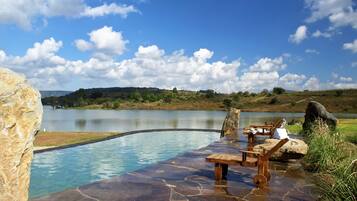 Alberca al aire libre y camastros