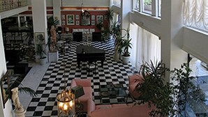 A spacious room with a checkered floor, a central table, and multiple seating areas. - Venus Melena (Hersonissos)