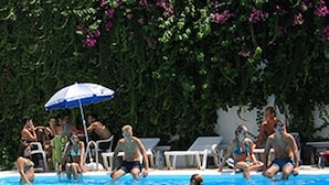 A swimming pool with people in the water and on the poolside. - Venus Melena (Hersonissos)