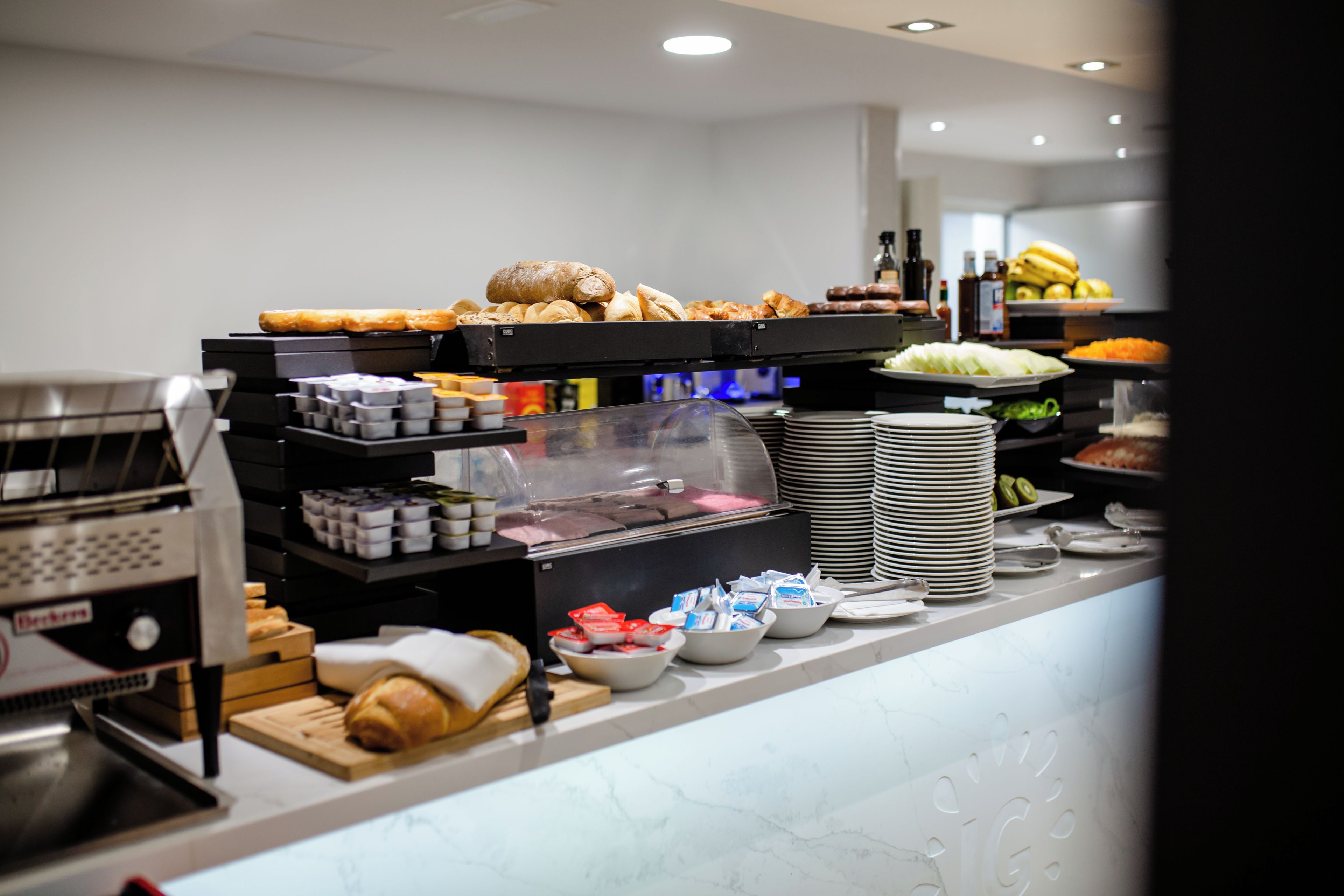 A buffet with various food items and a coffee machine.