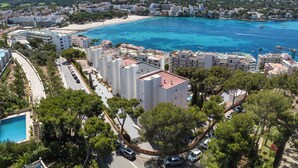 A coastal hotel with multiple buildings, a beach, and a clear blue sea. - Vista Club Apartamentos (Calvia)