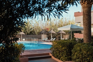 Outdoor pool, open 9:30 AM to 9:30 PM, pool umbrellas, pool loungers