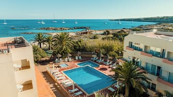 Outdoor pool, open 9:30 AM to 9:30 PM, pool umbrellas, pool loungers