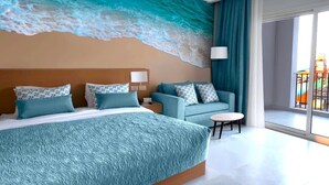 A hotel room with a large bed, a sofa, a small table, and a view of a colorful outdoor area. - Amwaj Beach Club Abu Soma - All inclusive (Safaga)