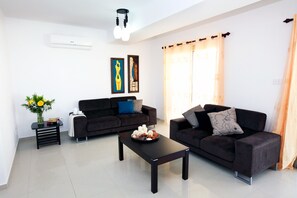 Suite, 3 Bedrooms, Sea View | Living room | 32-inch plasma TV with satellite channels, TV