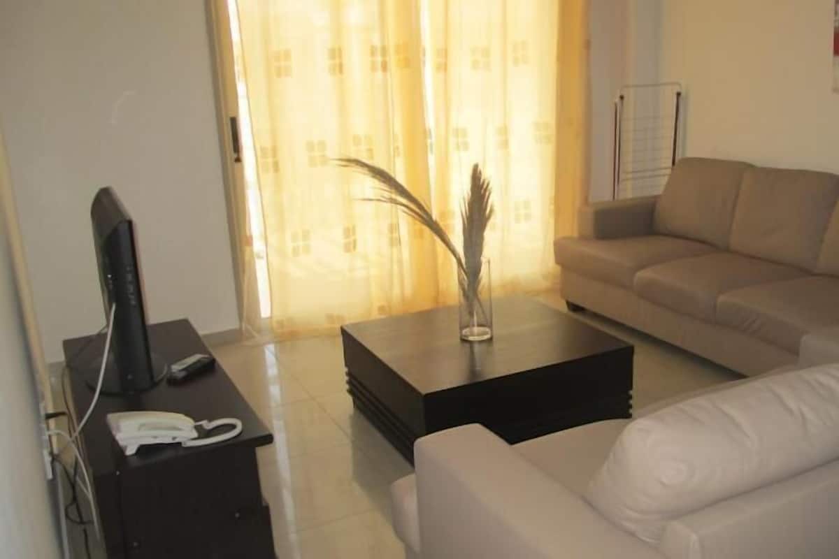 Suite, 2 Bedrooms, Pool View | Living area | 32-inch plasma TV with satellite channels, TV