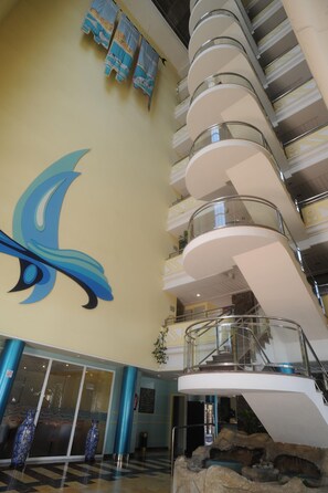 A multi-level interior with a large decorative wall, a staircase, and a reception area. - Tropic Relax (Finestrat)