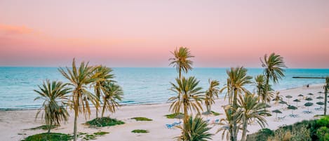 On the beach, sun-loungers, beach umbrellas