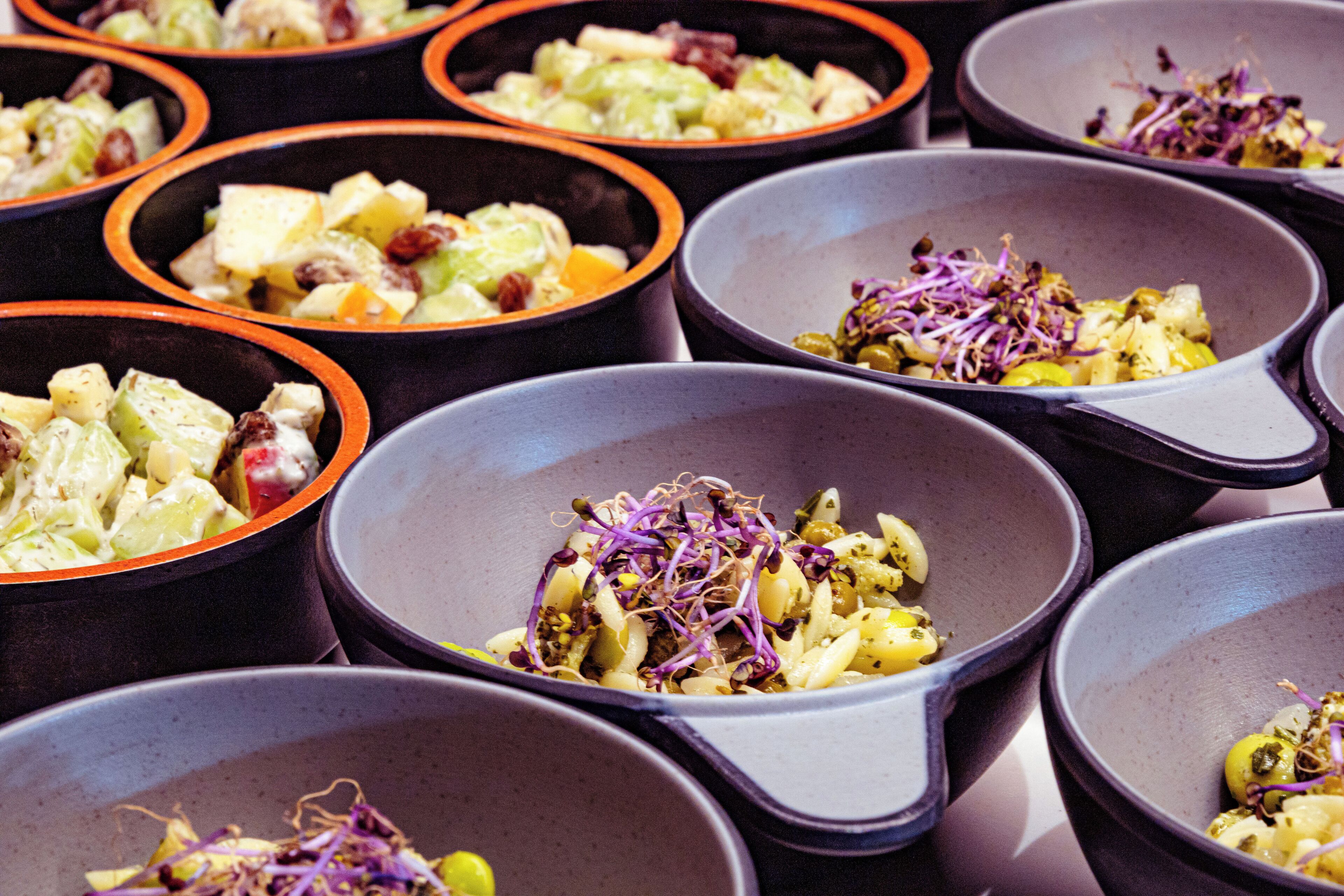 Multiple bowls of food with different ingredients.