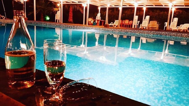 A poolside area with a covered seating area and lounge chairs. - Le Terre di San Domenico (Augusta)
