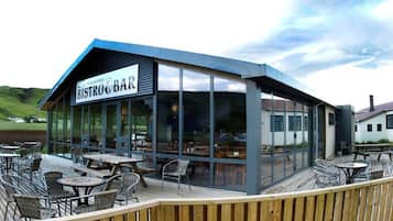 A restaurant with a sign reading 'BISTRO BAR' and a view of the surrounding landscape.