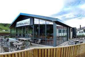 A restaurant with a sign reading 'BISTRO BAR' and a view of the surrounding landscape. - Hotel Skógafoss by EJ Hotels (Rangárþing eystra)