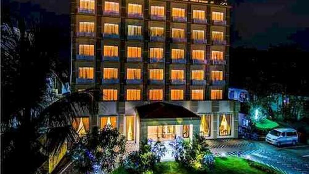 A multi-story hotel with illuminated windows and a sign reading "RENO HOTEL". - Reno Hotel (Yangon)
