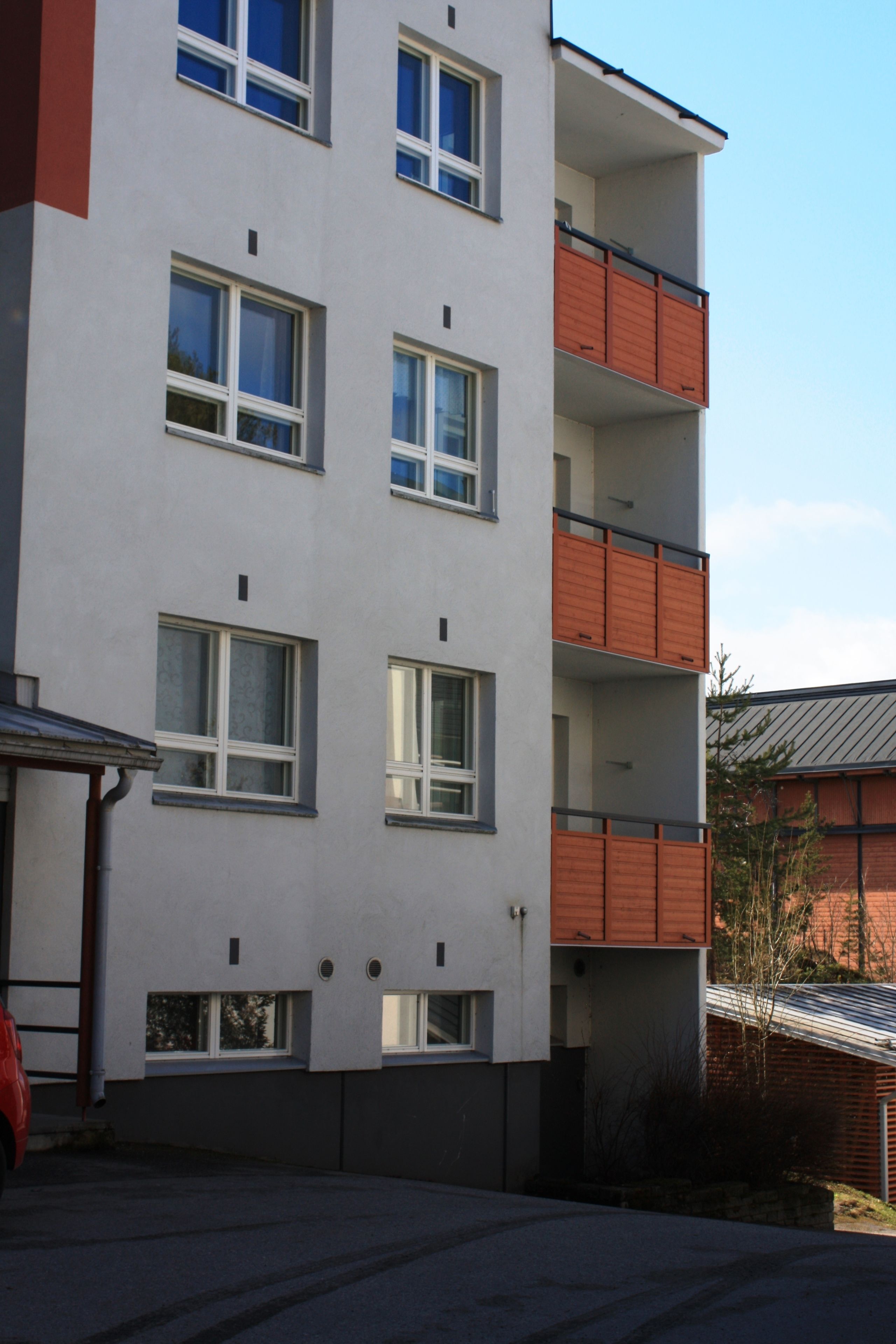 A multi-story building with balconies and windows.